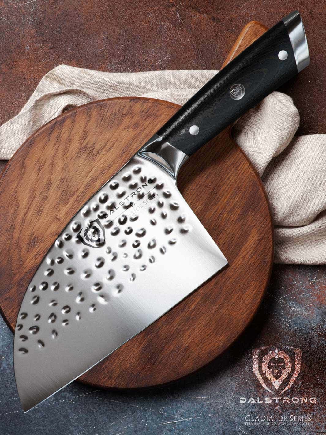 Dalstrong gladiator series 7.5 inch serbian knife with black handle on top of a round wooden cutting board.