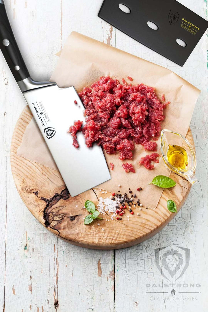 Dalstrong gladiator series 7 inch cleaver knife with black handle and sheath beside some ground meat on a wooden board.