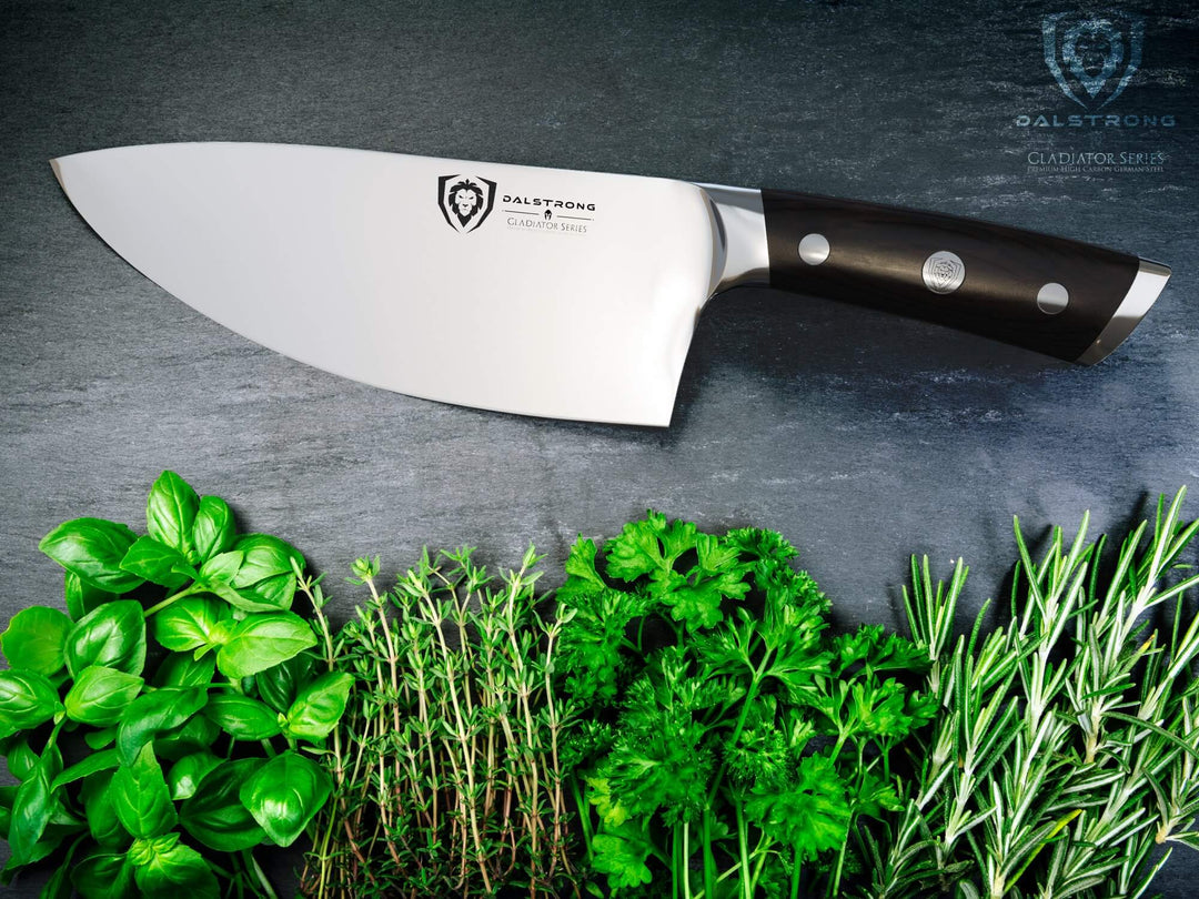 Dalstrong gladiator series 7 inch rocking herb knife with black handle and different green herbs at the bottom.