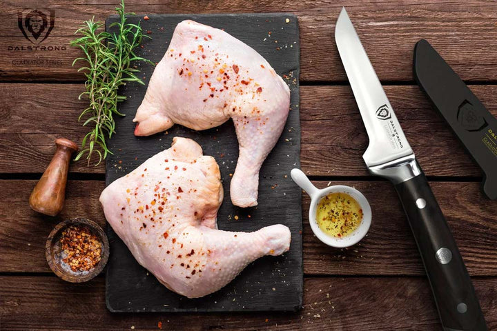 Dalstrong gladiator series 3.75 inch boning knife with black handle and sheath beside two pieces of chicken.