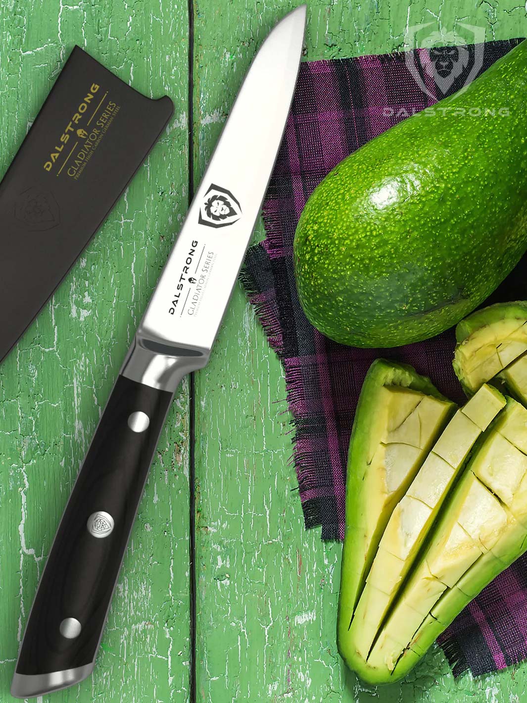 Dalstrong gladiator series 3.5 inch paring knife with black handle and an avocado sliced in half at the side.