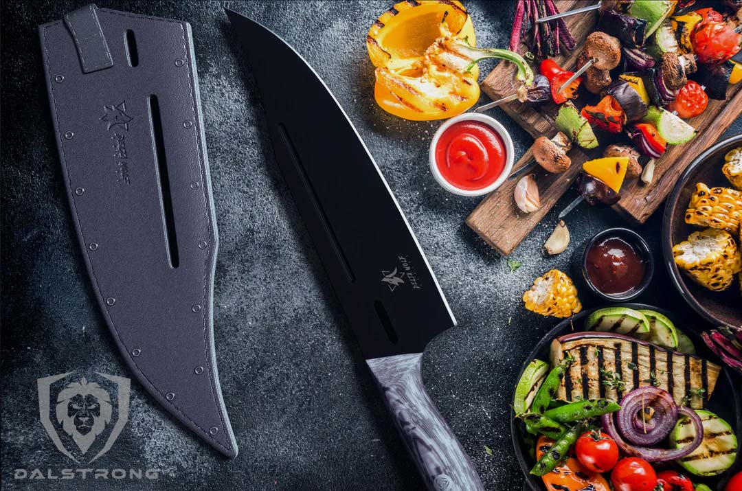 Dalstrong delta wolf series 8 inch chef knife with black blade and sheath beside some grilled vegetables.