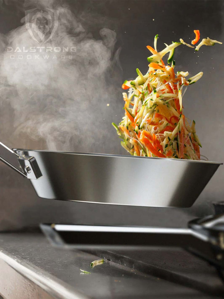 Dalstrong oberon series 10 inch frying pan skillet silver with stir fry vegetables.