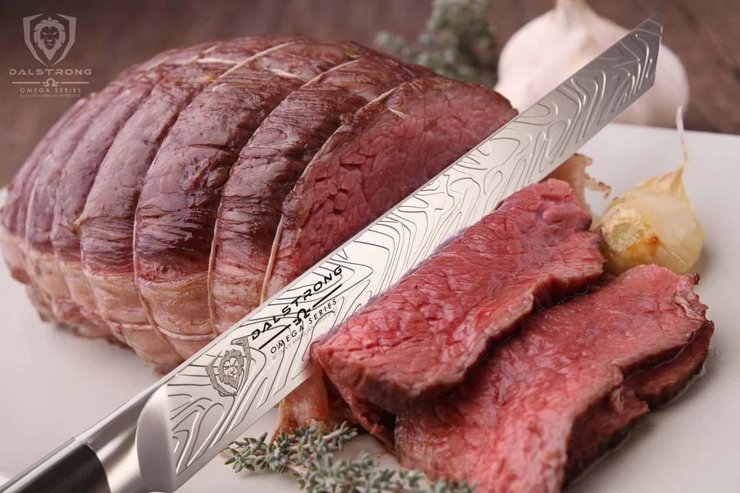 Dalstrong omega series 12 inch slicer knife with slices of meat on a white cutting board.