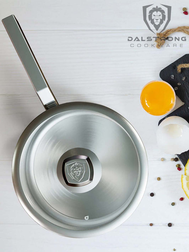Dalstrong oberon series 4 quart stock pot silver with egg yolk at the side.
