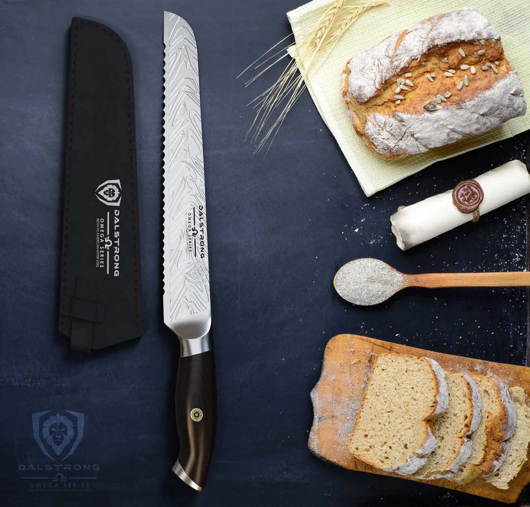 Dalstrong omega series 9 inch bread knife with black sheath beside slices of bread on a cutting board.