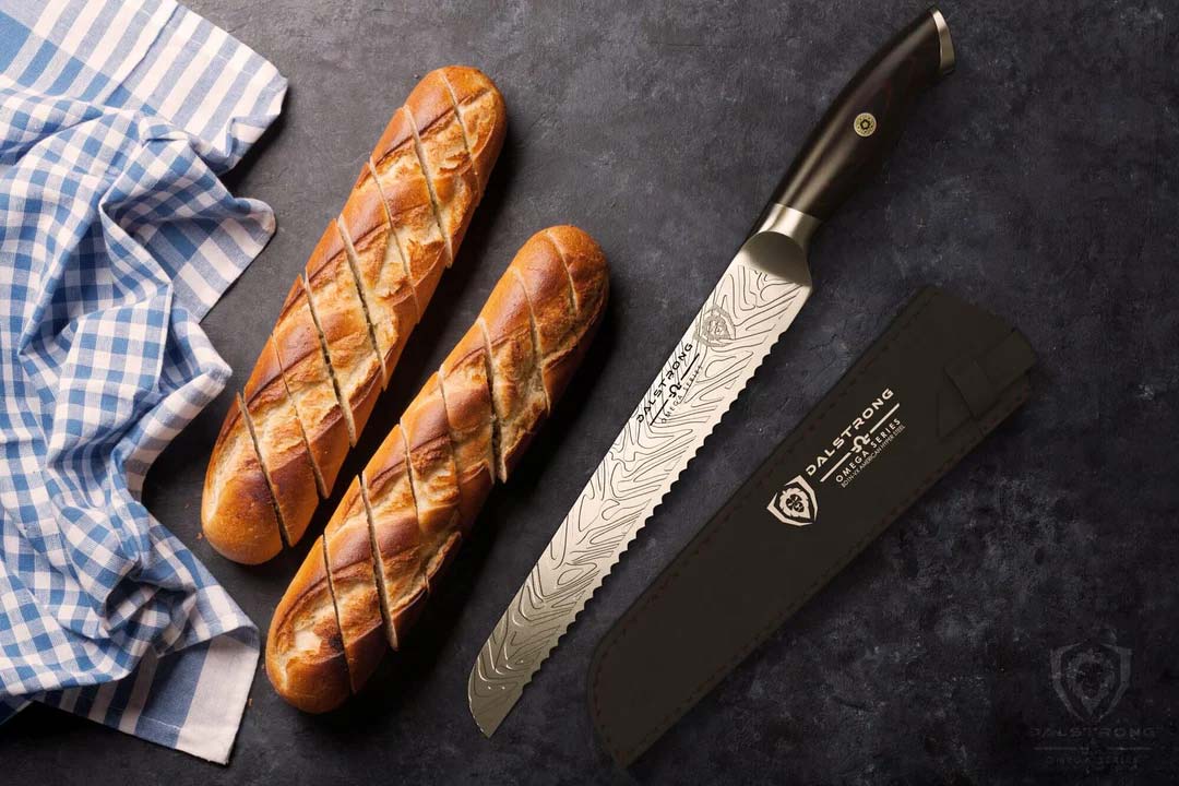 Dalstrong omega series 9 inch bread knife with black sheath beside two whole bread.