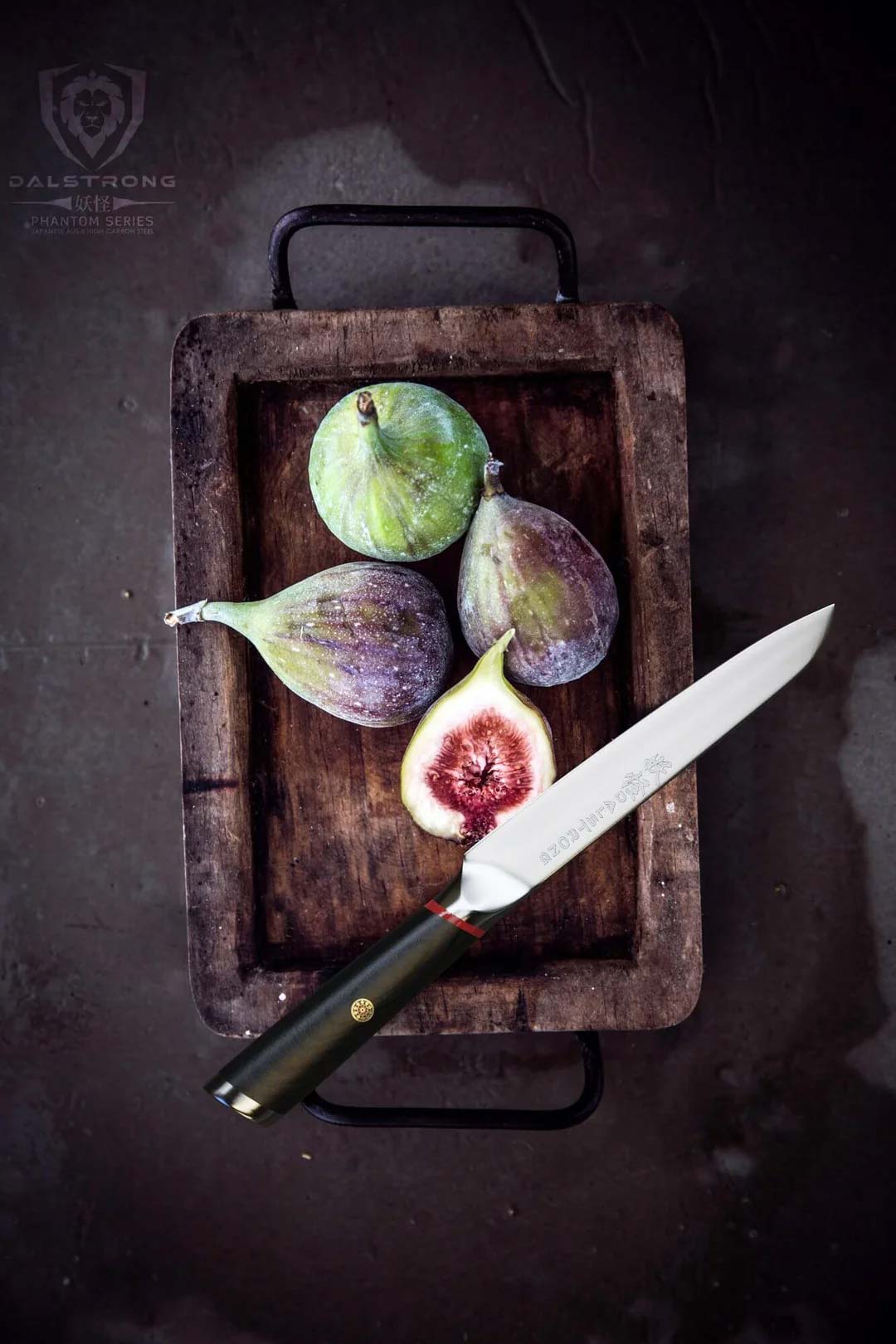 Dalstrong phantom series 5 inch utility knife with pakka wood handle and black sheath beside four fig fruit on a wooden container.