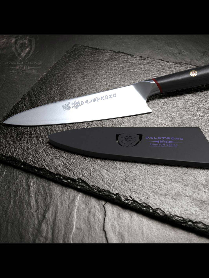 Dalstrong phantom series 8 inch chef knife with pakka wood handle and black sheath on top of a marble board.