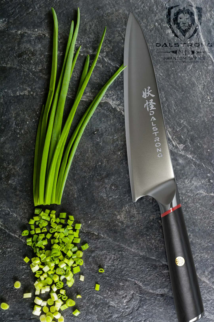 Dalstrong phantom series 8 inch chef knife with pakka wood handle and chopped scallions at the side.