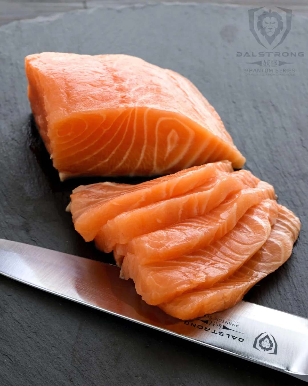 Dalstrong phantom series 9.5 inch yanagiba knife with pakka wood handle and slices of salmon meat.