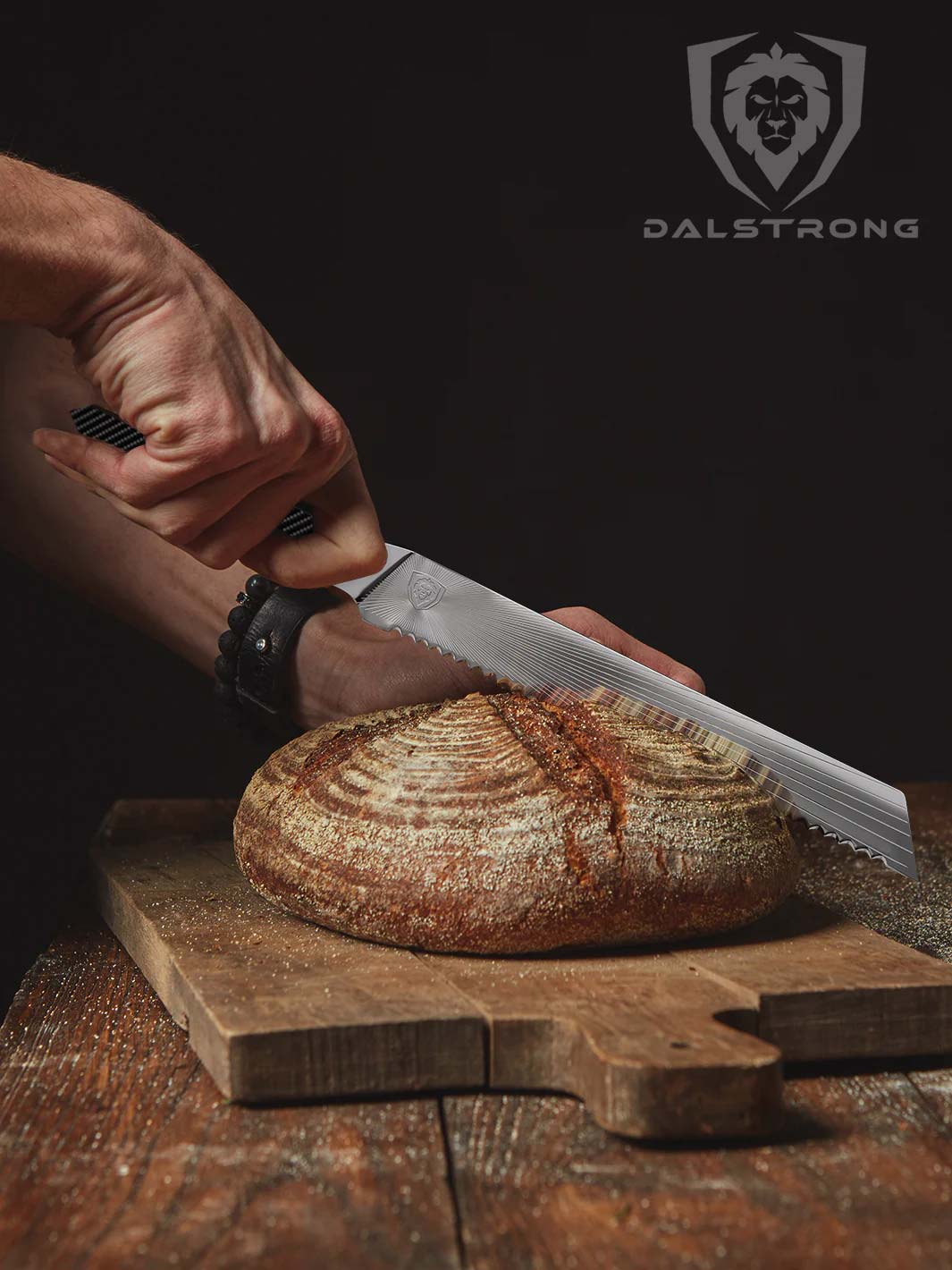 Dalstrong quantum 1 series 9 inch bread knife with dragon skin handle and a whole bread on a cutting board.
