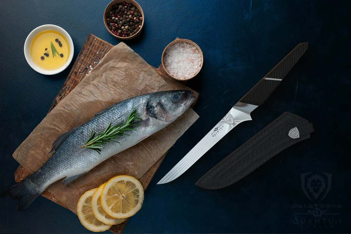 Dalstrong quantum 1 series 6 inch boning knife with dragon skin handle and a whole fish on top of a cutting board.