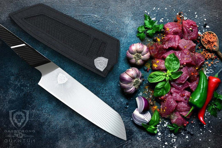 Dalstrong quantum 1 series 7 inch santoku knife with dragon skin handle beside small cuts of meat and chilli.