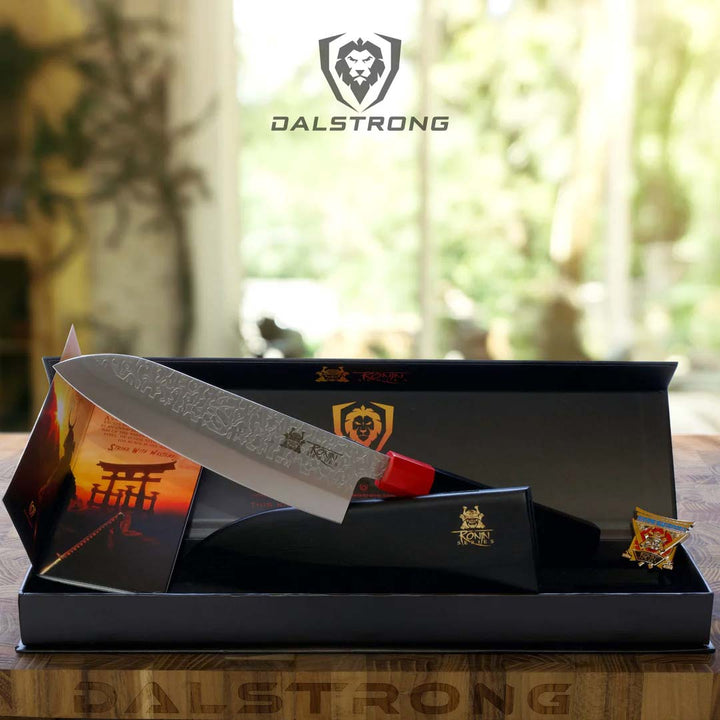 Dalstrong ronin series 7 inch santoku knife with black handle and sheath outside it's premium packaging.