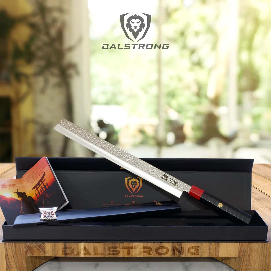 Dalstrong ronin series 12 inch slicing knife with black handle outside it's premium packaging.