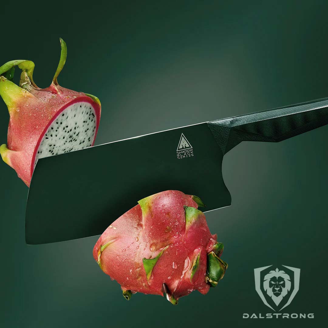 Dalstrong shadow black series 7 inch cleaver knife with a dragon fruit cut in half.