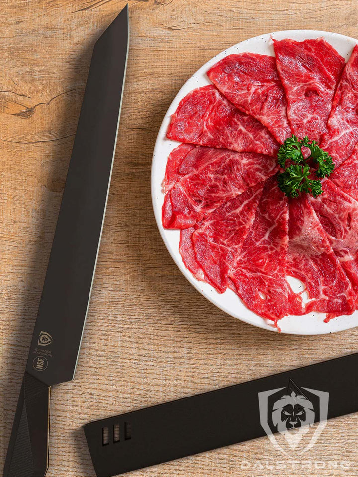 Dalstrong shadow black serie 10.5 inch yanagiba knife with black sheath beside a thin slices of meat.