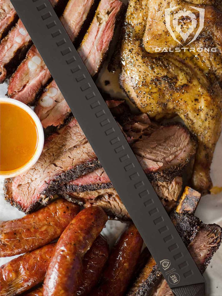 Dalstrong shadow black series 14 inch slicer knife with different kinds of barbeque meats.
