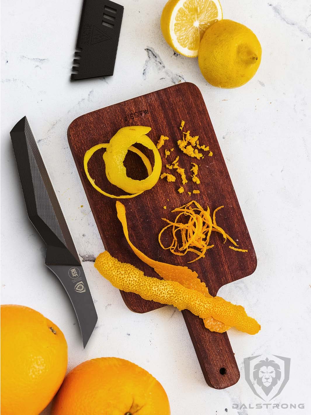 Dalstrong shadow black series 2.75 inch bird's beak paring knife with peeled orange on a wooden cutting board.