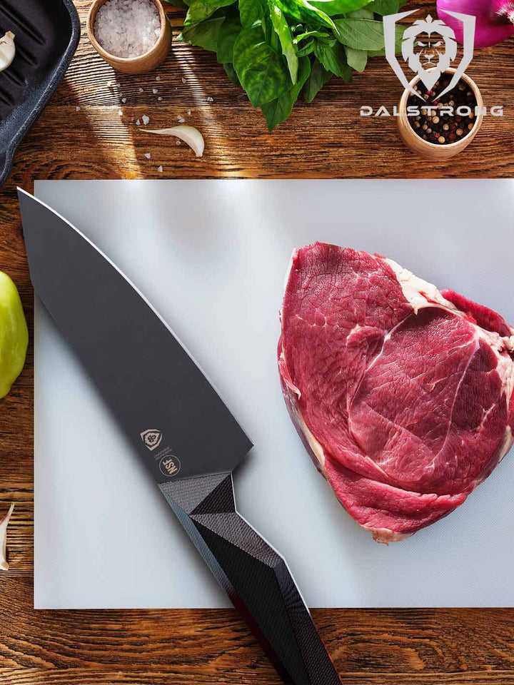 Dalstrong shawdow black series 6 inch chef knife with a piece of steak.