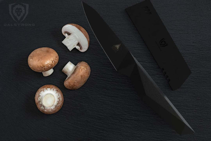 Dalstrong shadow black series 4 inch paring knife with two mushrooms cut in hallf.