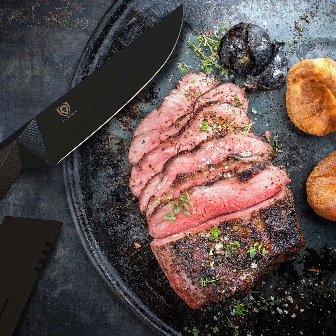 Dalstrong shadow black series steak knife set with black sheath beside slices of meat on a cutting board.
