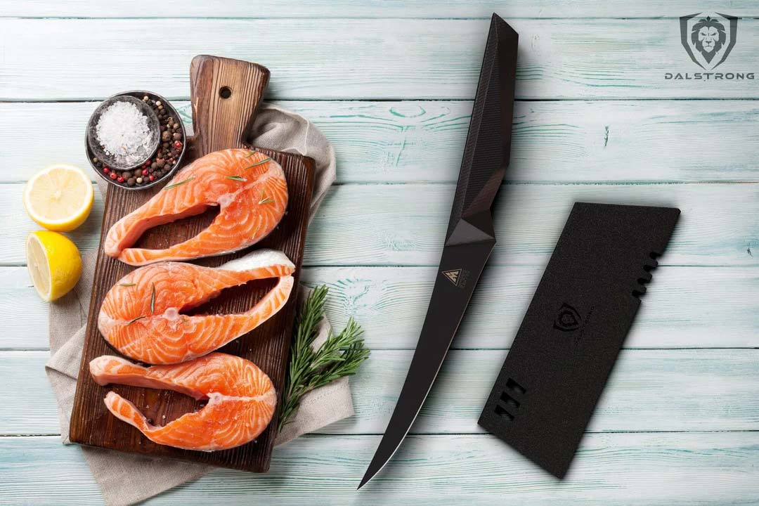 Dalstrong shadow black series 6 inch curved boning knife with black sheath and three fillets of fish on a cutting board.