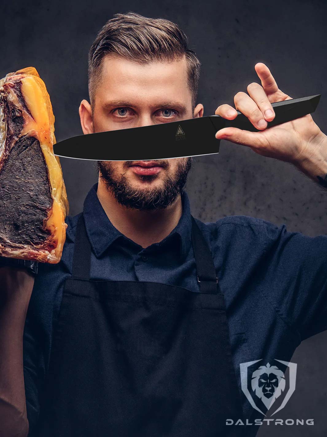 A man holding the dalstrong shadow black series 8 inch chef knife with a dry aged steak on the other hand.