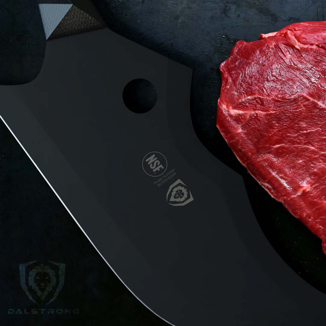 Dalstrong shadow black series 9 inch cleaver knife beside a cut of meat.