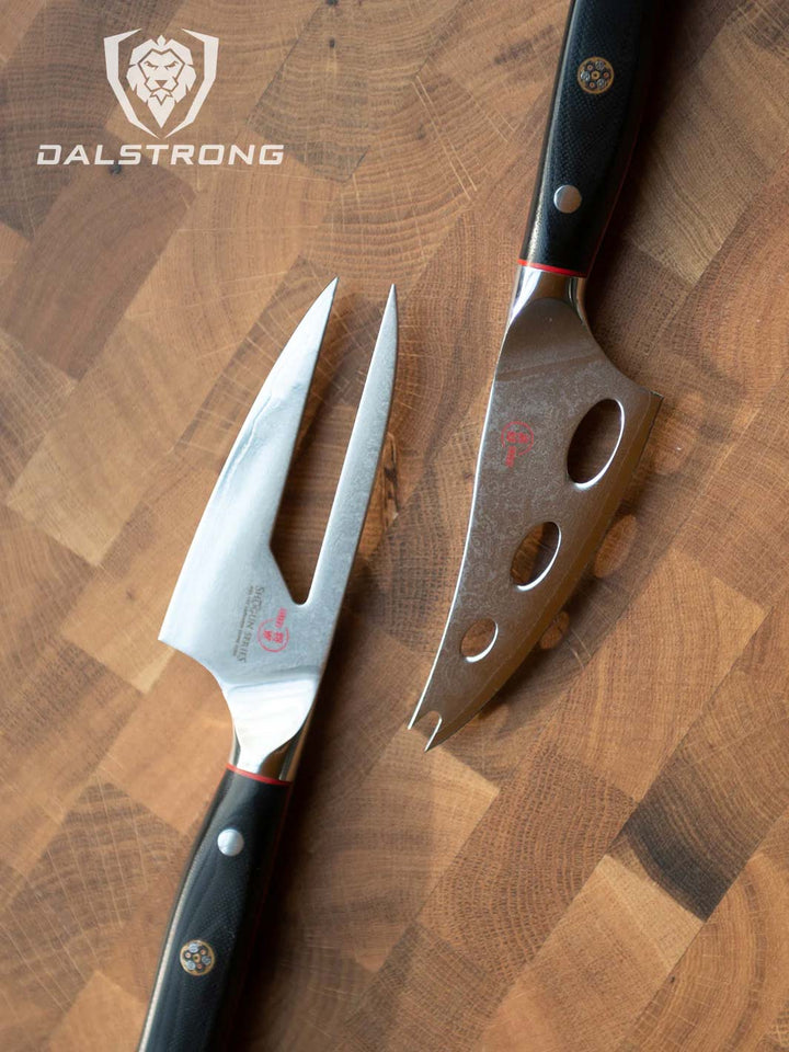 Dalstrong shogun series cheese knives with black handles on top of a wooden board.