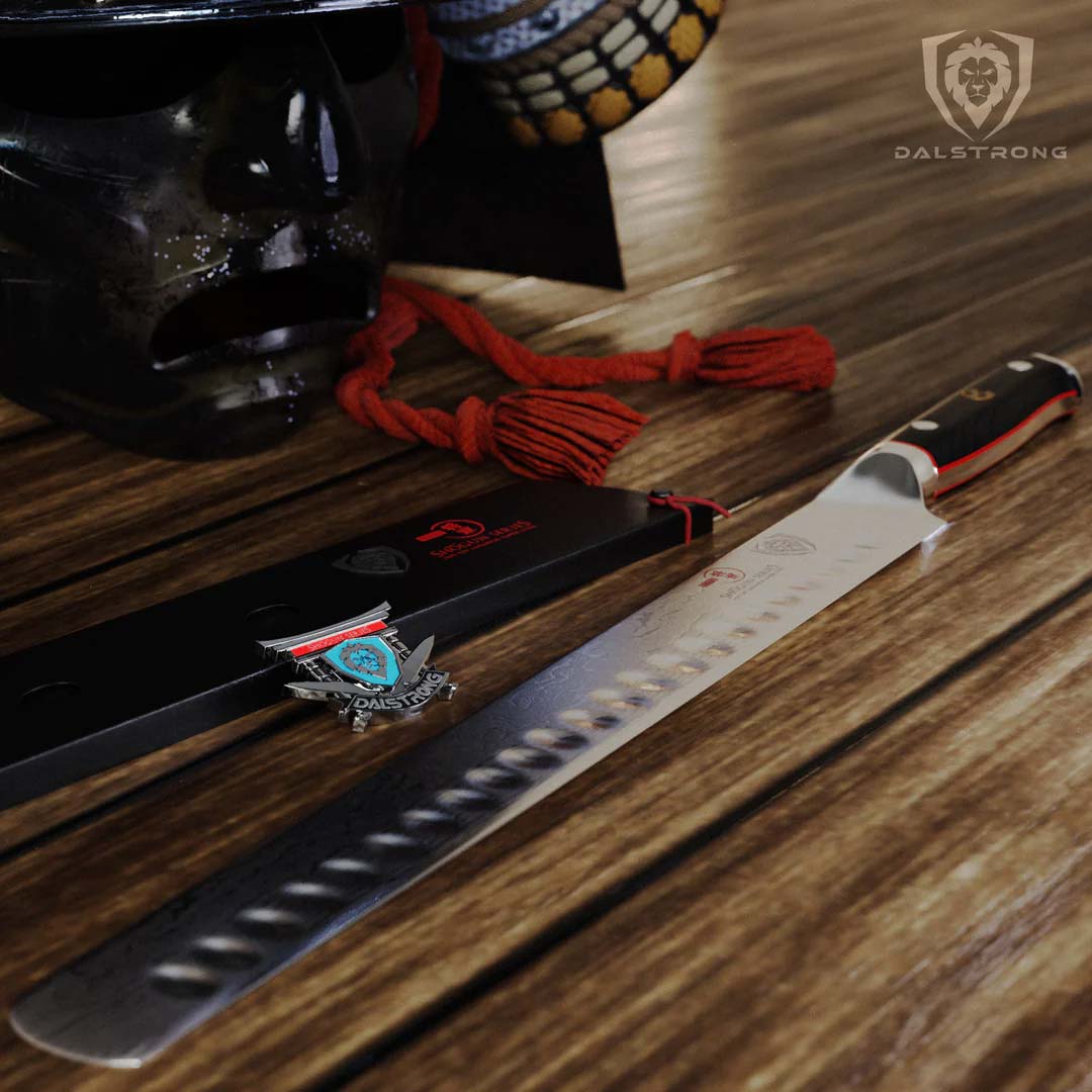Dalstrong shogun series 12 inch slicer knife with black handle and sheath in top of a wooden table.