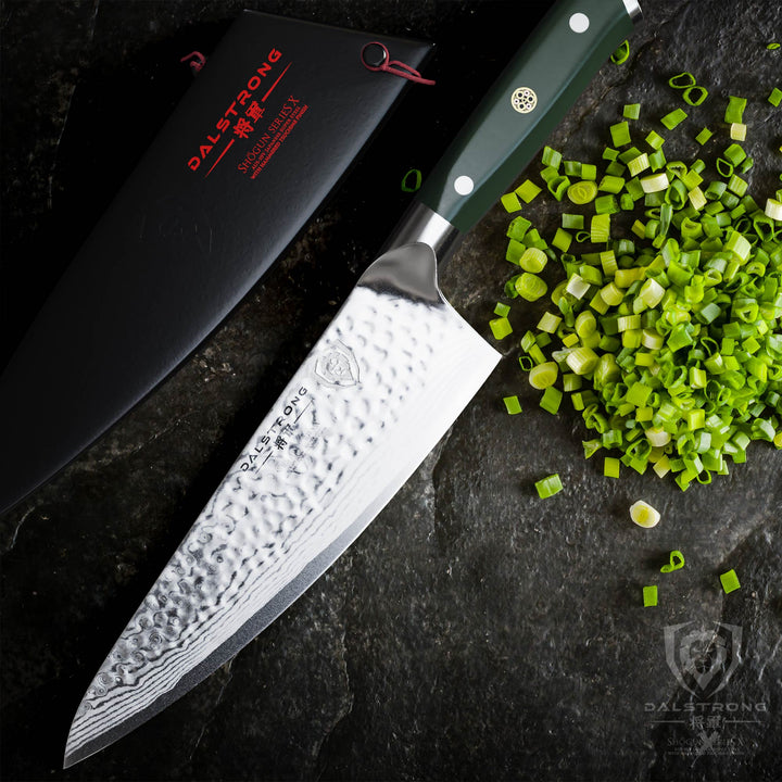 Dalstrong shogun series 8 inch chef knife with army green handle and chopped scallions.