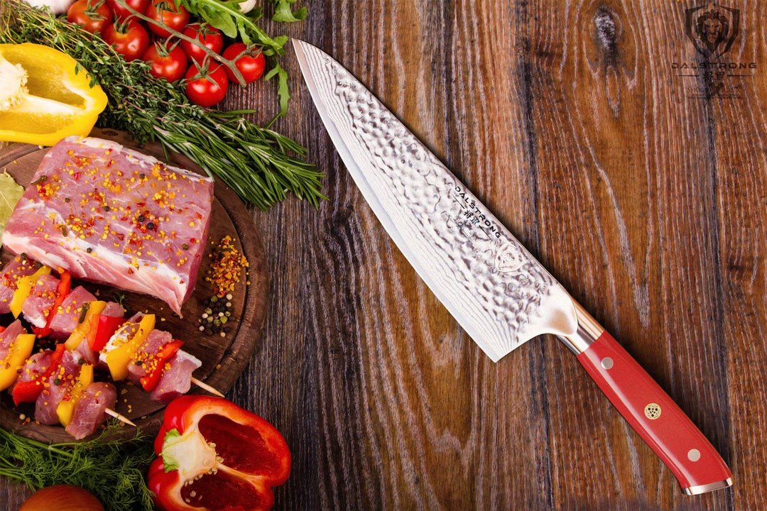 Dalstrong shogun series 8 inch chef knife with crimson red handle and slices of meat on a wooden table.
