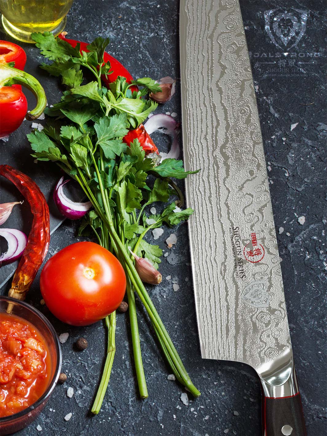 Dalstrong shogun series 12 inch chef knife with black handle beside some herbs.
