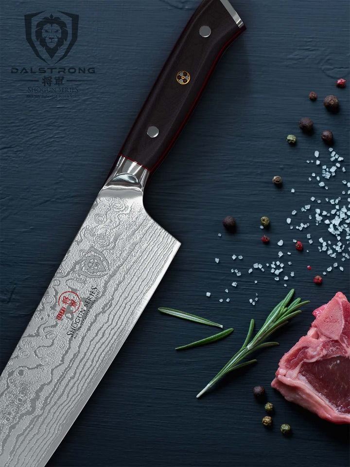 Dalstrong shogun series 12 inch chef knife with black handle beside a slice of meat.