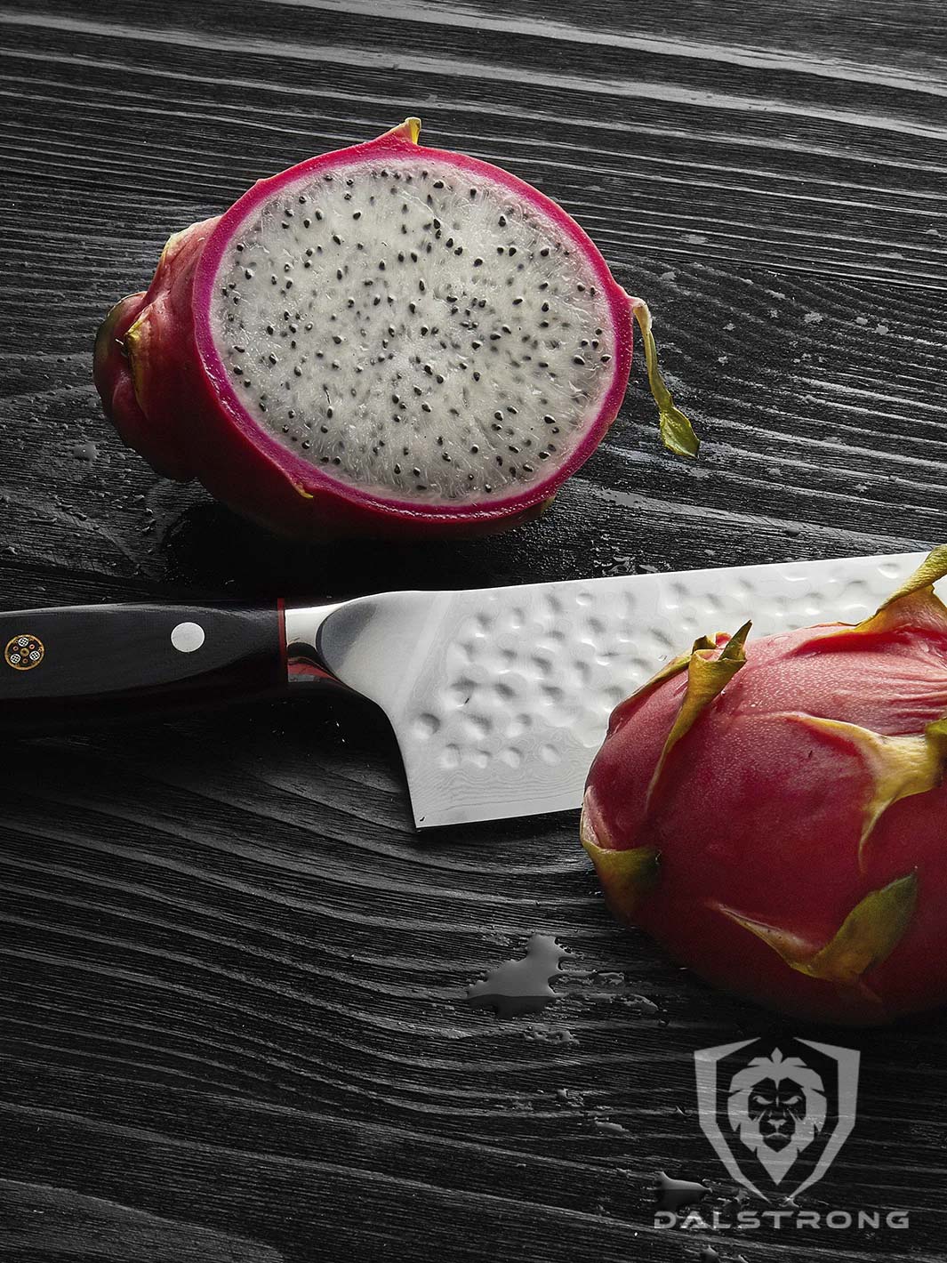 Dalstrong 8 inch chef knife with black handle in between a sliced dragon fruit in half. 