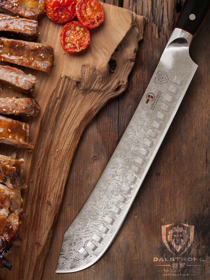 Dalstrong shogun series 10 inch bullnose butcher knife with black handle and slices of ribs on a wooden board.