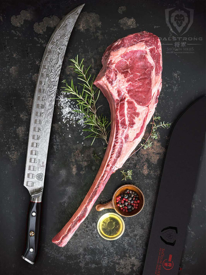 Dalstong shogun series 12.5 inch butcher knife with black handle and sheath beside a tomahawk steak.