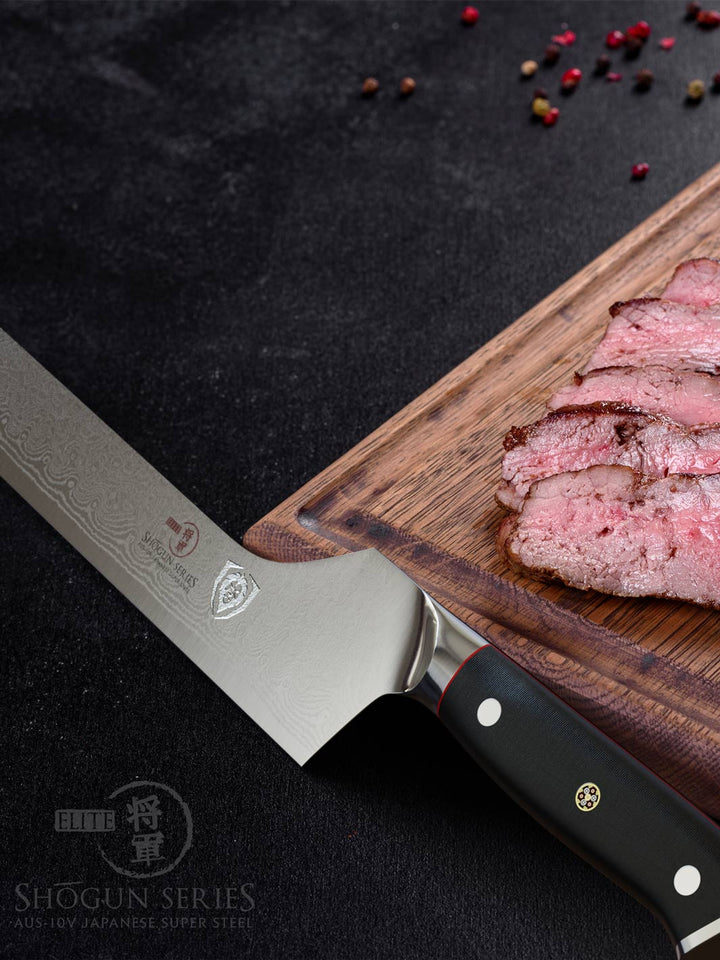 Dalstrong shogun series 12 inch offset slicer knife with black handle and slices of steak on a wooden board.