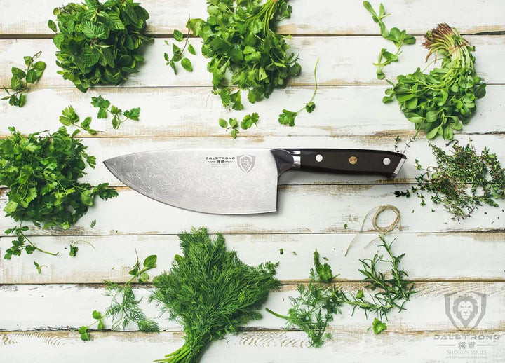 Dalstrong shogun series 7 inch rocker cleaver knife with black handle surrounded by different kinds of herbs.