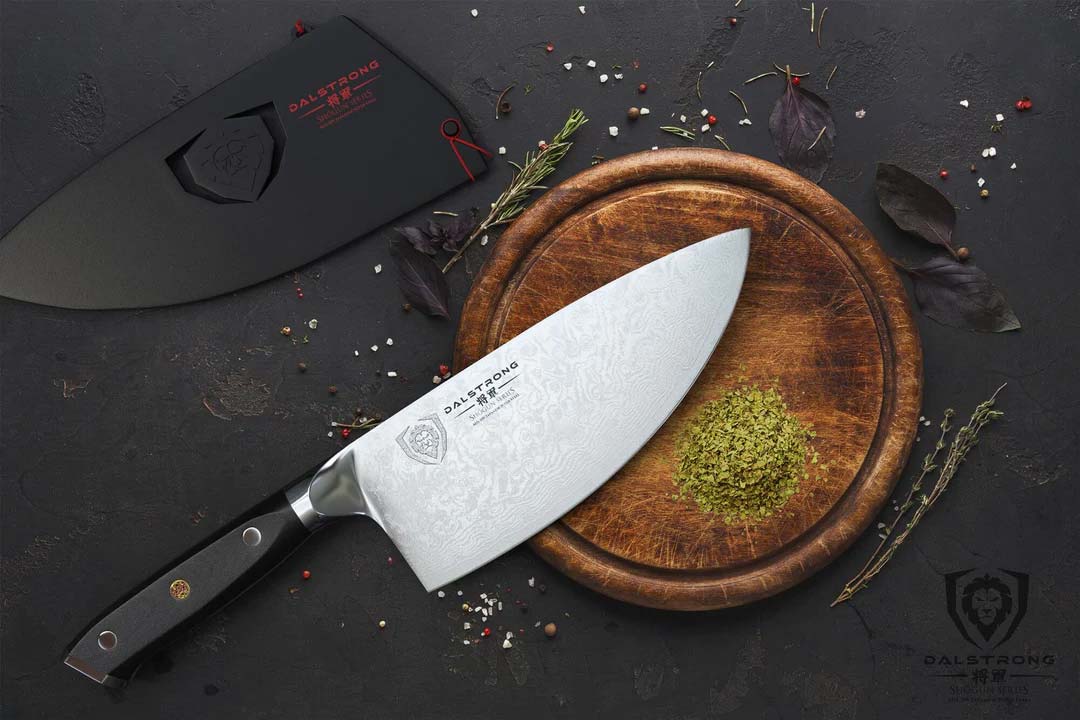 Dalstrong shogun series 7 inch rocker cleaver knife with black handle and sheath on top of a wooden board.
