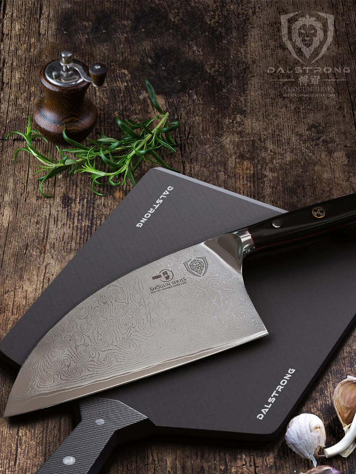 Dalstrong shogun series 8 inch serbian chef knife with black handle on top of a Dalstrong fibre cutting board.