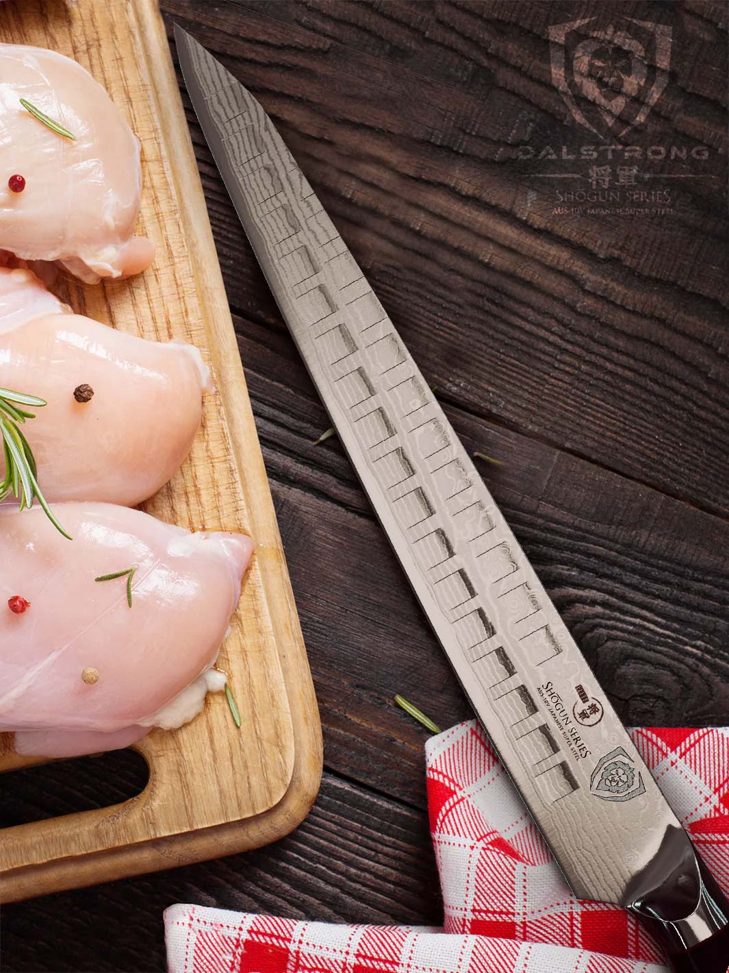 Dalstrong shogun series 10.5 inch sujihiki slicing knife and three cuts of chicken meat on a wooden board.