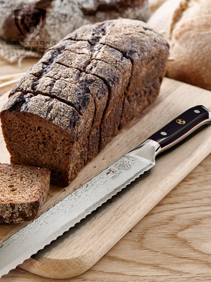Dalstrong shogun series 10.25 inch bread knife with black handle and sliced bread on a wooden table.