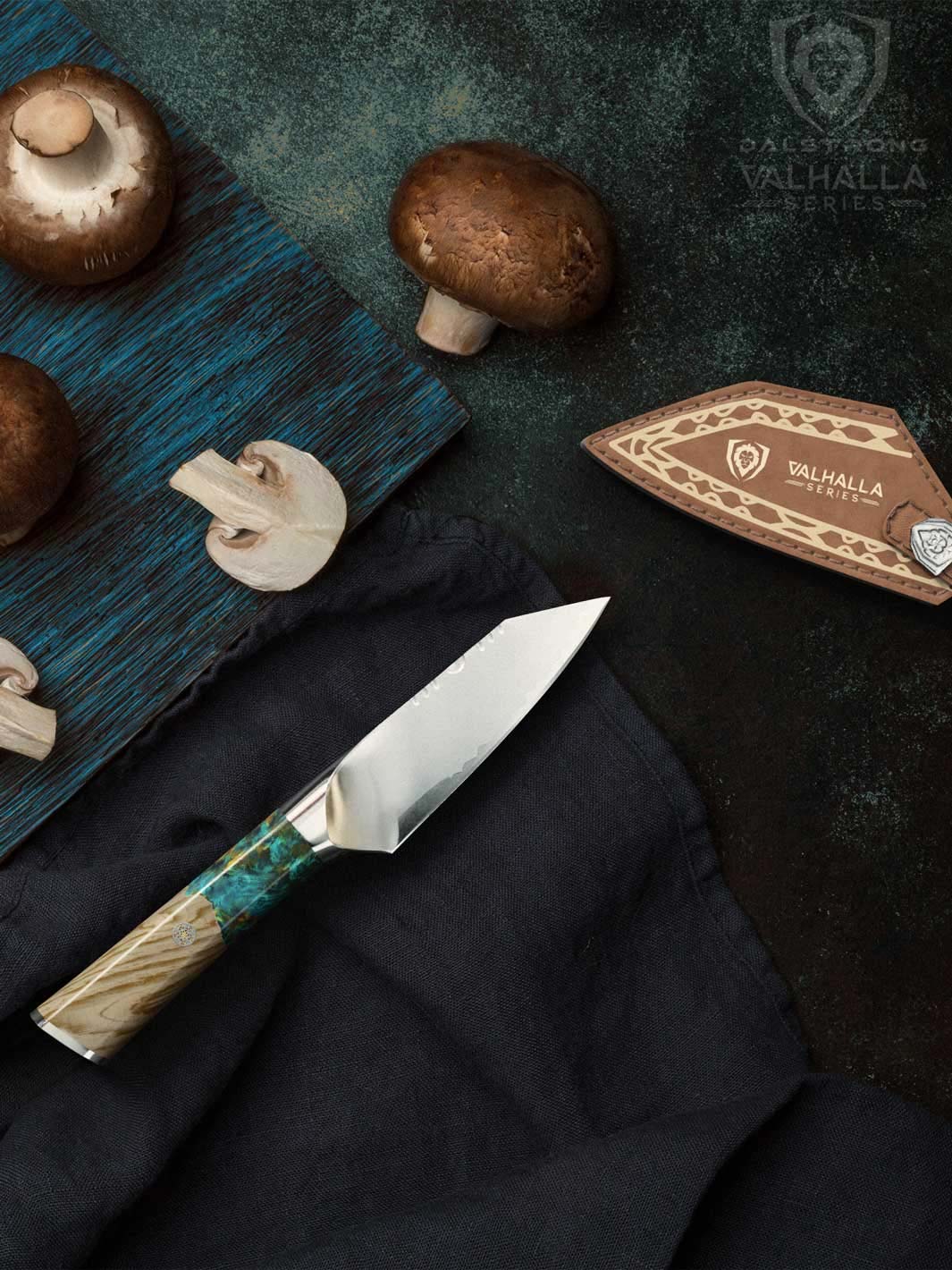 Dalstrong valhalla series 4 inch paring knife with wooden handle beside some mushrooms.