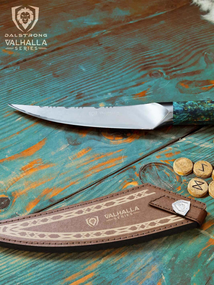 Dalstrong valhalla series 6.5 inch fillet knife with wooden handle and it's sheath on top of a table.