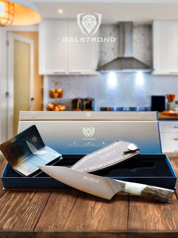 Dalstrong valhalla series 8 inch chef knife with glacial white handle and sheath outside it's premium packaging.