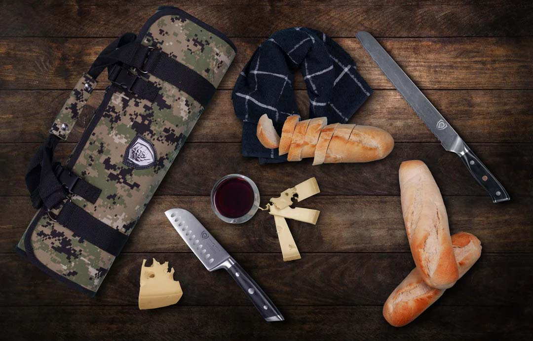 Dalstrong ballistic series camouflage premium knife roll beside two knives and slices of bread.