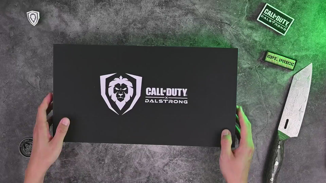 Unboxing the Dalstrong call of duty canvas chef apron black waxed canvas on a wooden cutting board.